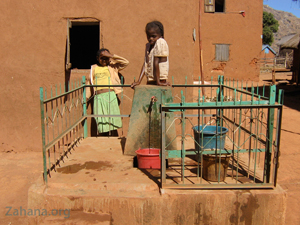 Communal water well protected by metal fence in Madagascar.  zahana.org